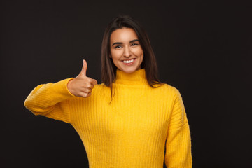 Smiling woman showing thumb up