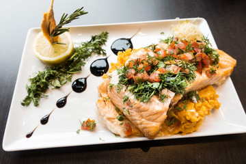 grilled salmon and lemon - french cuisine dish with tomato and salmon