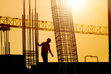 Construction worker at site in sunset