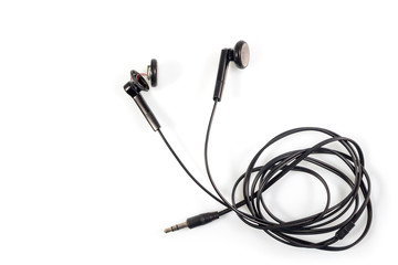 Top view of broken old black earphones or headphones on white background.