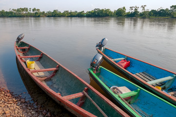 Naklejka na ściany i meble canoe propelled by motor in colombia river