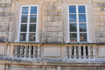 two old wooden windows on stone wall close up 