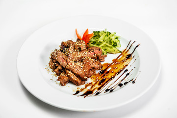 meat salad on a plate with cucumber and tomato