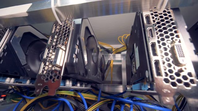 Graphic cards working connected into mining cryptocurrency farm. 4K.