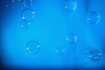 Rainbow soap bubbles on a blue backgrounds