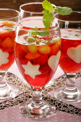 Red jelly dessert with strawberries, grapes and apricots
