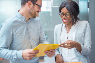 Two business people discussing about work in an office.