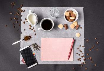 Time for break, coffee and chocolate, business concept with smartphone, keys, credit cards, notebook and pen