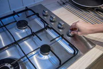 Woman's Hands adjusting temperature button on oven