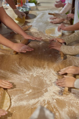 Blurred photo of people cooking cake at cooking classes