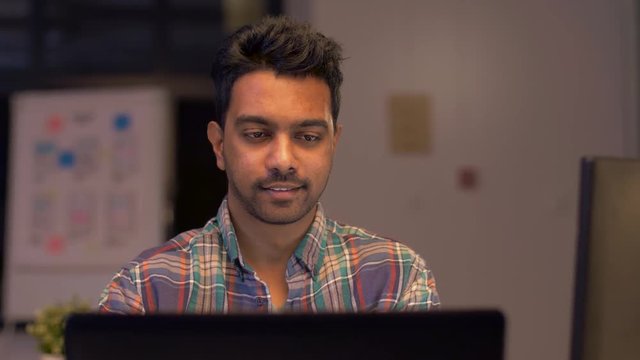 deadline, technology and people concept - creative man or programmer with computer working at night office