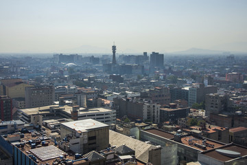 Fototapeta premium Aerial view of a neighborhood called Colonia Juarez in Mexico City, Mexico, on a sunny morning with some haze.