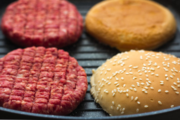 raw burger in grill pan 
