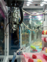 Robotic arms with clamp over plastic dispenser for controller.