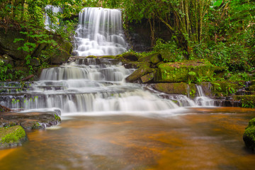 Fototapeta na wymiar Mun daeng Waterfall, the beautiful waterfall in deep forest at Phu Hin Rong Kla National Park ,Phitsanulok, Thailand