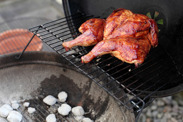 BBQ Spatchcock chicken cooking on the grill.