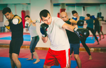 Portrait of  females and  males training in boxing gloves