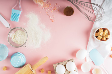 Frame of food ingredients for baking on a gently pink pastel background. Cooking flat lay with copy space. Top view. Baking concept. Mockup.