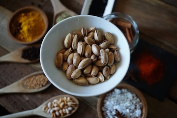 pistachio nuts in a bowl with species.