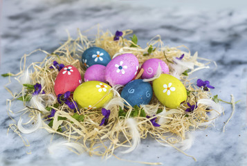Fototapeta na wymiar Colorful Easter Eggs on a Marble Background