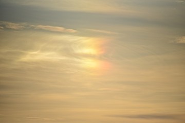 Halo in the sky. Colored rainbow on the clouds.
