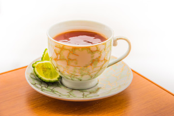 Hot tea with bergamot on wooden table in the cold. Winter.