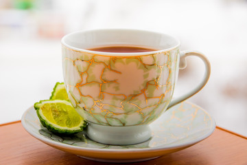 Hot tea with bergamot on wooden table in the cold. Winter.