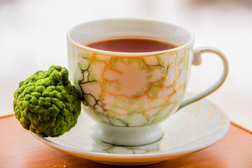 Hot tea with bergamot on wooden table in the cold. Winter.