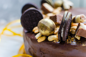 Appetizing chocolate cake with sweets and biscuits. Modern decoration of cake. A great birthday cake!