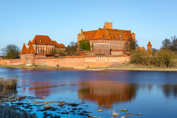 Fototapeta na wymiar Malbork Castle from across the Nogat. Poland