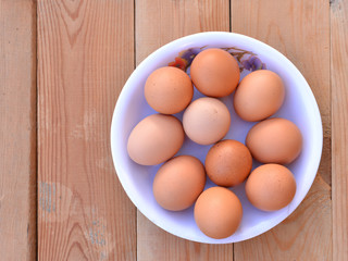 Bowl of eggs on the wooden background