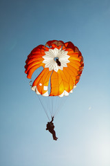 Parachutist with a colorful parachute round.