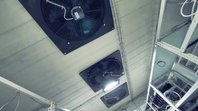Cooling system with lot of industrial fans in a cryptocurrency mining factory.