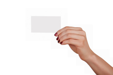 Obraz premium Well-groomed female hand with manicure and red lacquer holding an empty white card