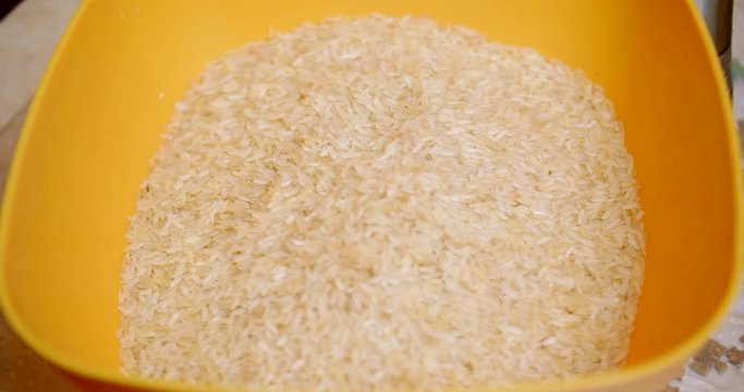 Rice is poured into a bowl