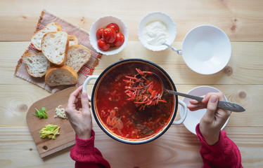 Traditional Ukrainian Russian vegetable borscht on the old wooden background
