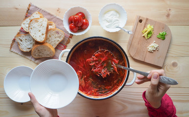 Traditional Ukrainian Russian vegetable borscht on the old wooden background
