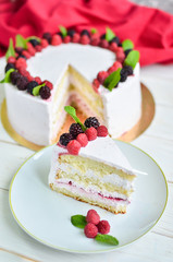 Delicious festive cake with fresh raspberries, blackberries and rosemary