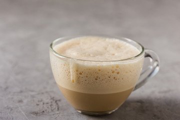 Cup of coffee steamed with cream