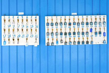 Daylight view to white key wall with numbers on bright blue facade