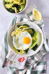 Healthy breakfast: lettuce salad, fried egg and french sauce supreme