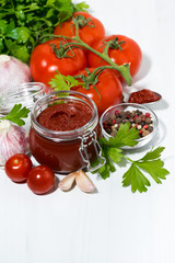 fresh tomato sauce and ingredients on white background, vertical top view