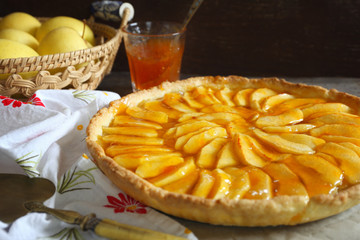 French cuisine: traditional apple tart with apricot jam