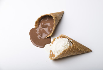 Variety of ice cream scoops in cones with chocolate, vanilla and strawberry
