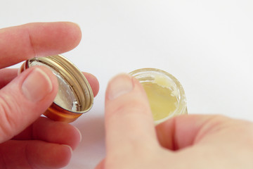 Hands using rich Oil or Chrism from a Crucible, on white background