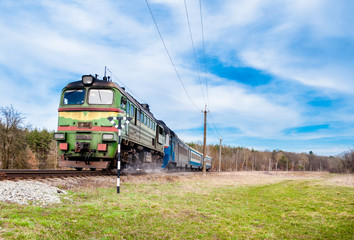 Naklejka premium train moves through the rails in forest