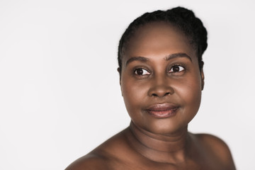 Smiling African woman with beautiful skin against a white background