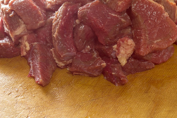 Raw meat is sliced for cooking.