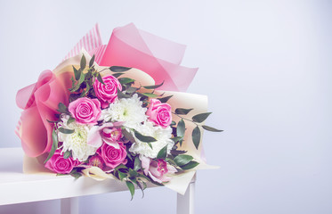 beautiful bouquet of bright rose flowers, on table with white background
