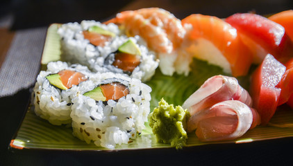 Sushi and sashimi set with wasabi and ginger on a plate